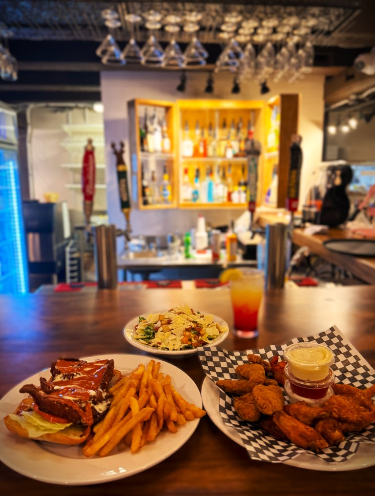 Burger, fries, wings, and a salad at the bar of Dick and Nellie's in Sioux Lookout